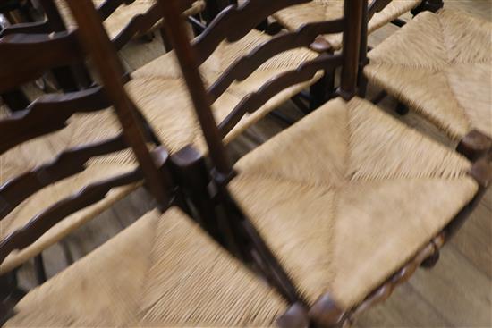 Eleven rush seat ladderback type chairs including two carvers